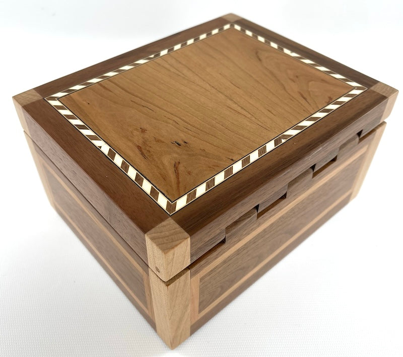 Custom made from Cherry, Oak and Black Walnut box with wooden hinge and Black felt interior. Black Walnut wooden hinge. Rope inlay border in cherry wood lid. Vertical edges are maple wood. Red and Blue felt inserts. - TreeToBox